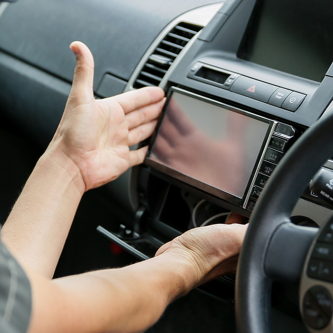 a person installing a touchscreen radio